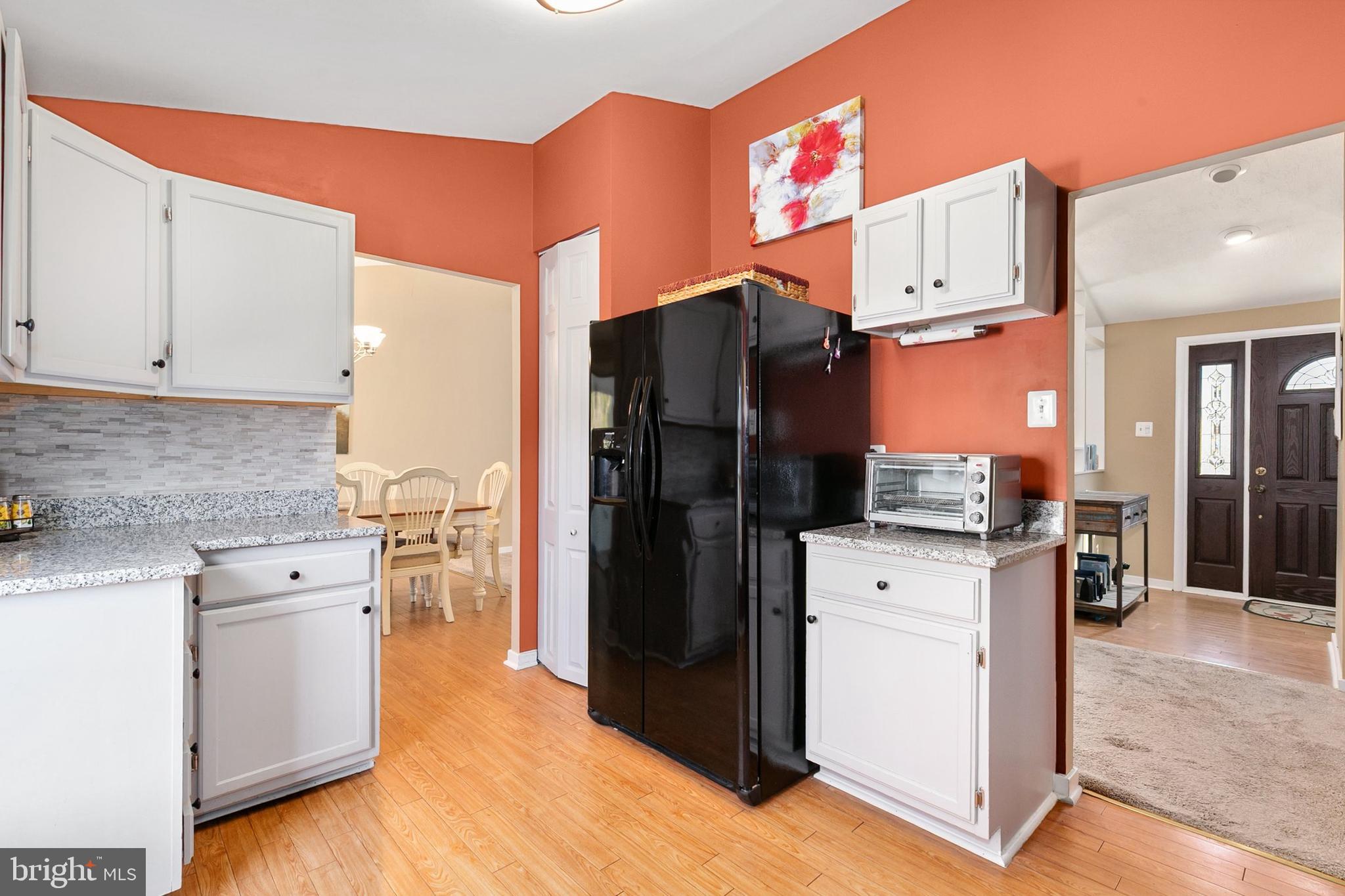 9348 Windbell Way Columbia, MD 21045 - Photo 9 of 37 a kitchen with a refrigerator and a stove top oven
