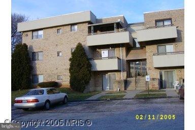 3928 Rolling Rd., Unit C3 Pikesville, MD 21208 - Photo 1 of 16 a front view of a house with a yard
