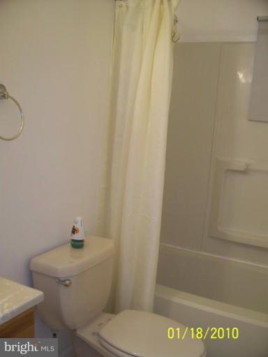 3928 Rolling Rd., Unit C3 Pikesville, MD 21208 - Photo 11 of 16 a white toilet sitting next to a bath tub