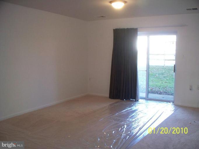3928 Rolling Rd., Unit C3 Pikesville, MD 21208 - Photo 14 of 16 an empty room with wooden floor and windows