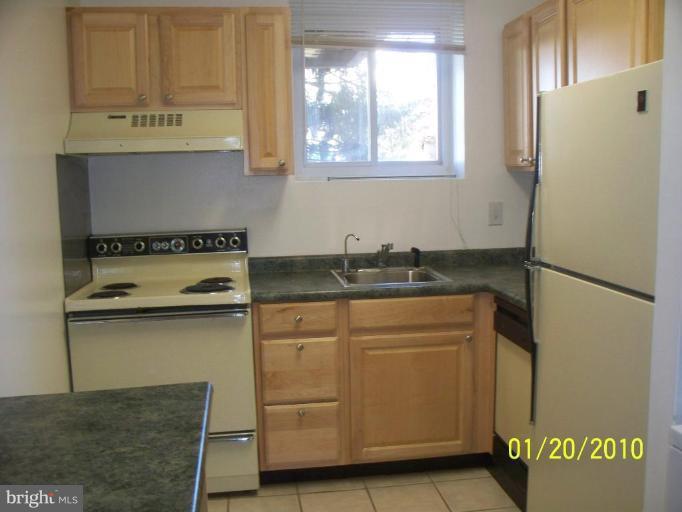 3928 Rolling Rd., Unit C3 Pikesville, MD 21208 - Photo 15 of 16 a kitchen with stainless steel appliances granite countertop a refrigerator and a stove