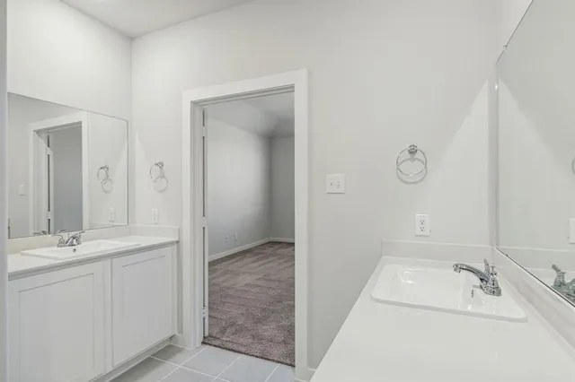 a bathroom with a tub sink and mirror