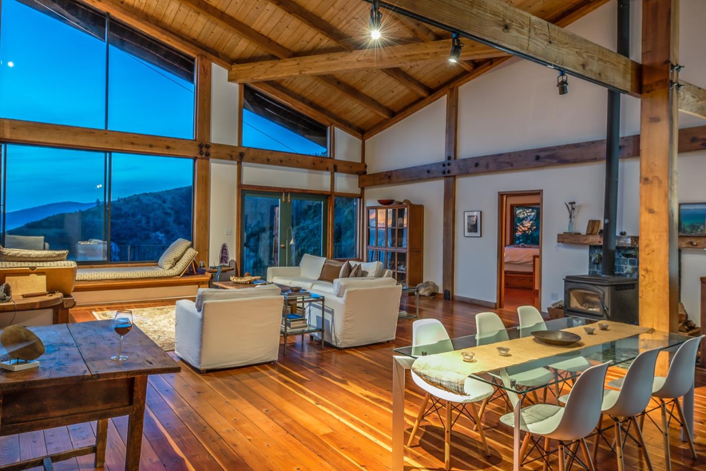 29141 Plasket Ridge Road Big Sur, CA 93920 - Photo 17 of 48 a view of a patio with dining table and chairs with wooden floor