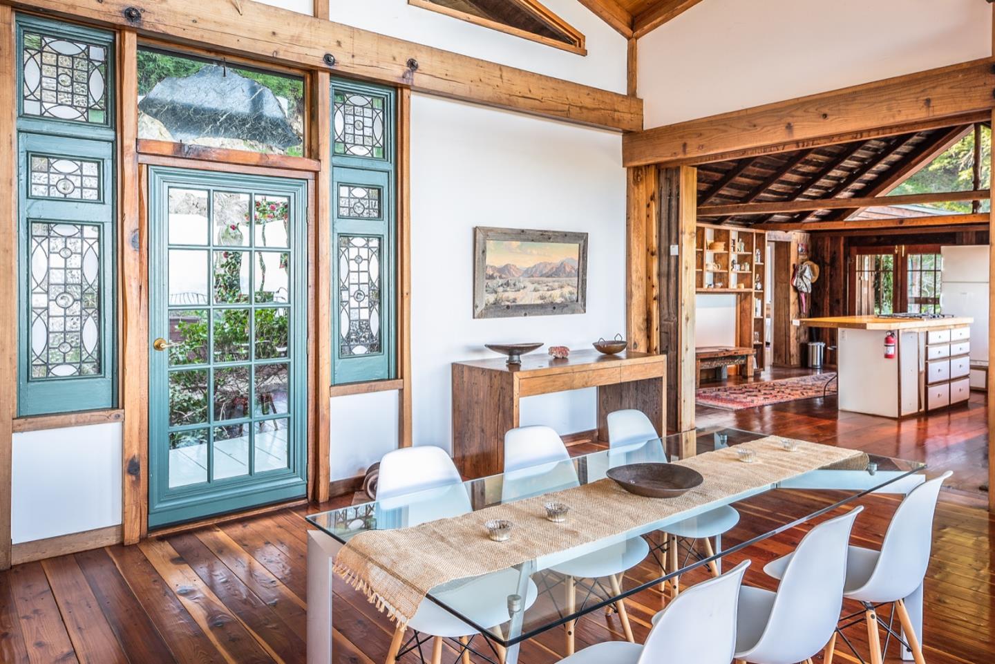 29141 Plasket Ridge Road Big Sur, CA 93920 - Photo 19 of 48 a view of a dining room and livingroom with furniture window and wooden floor