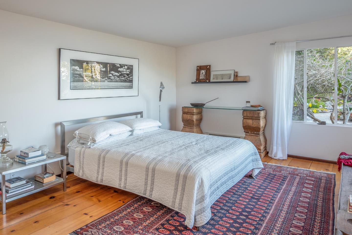 29141 Plasket Ridge Road Big Sur, CA 93920 - Photo 28 of 48 a bedroom with bed and wooden floor