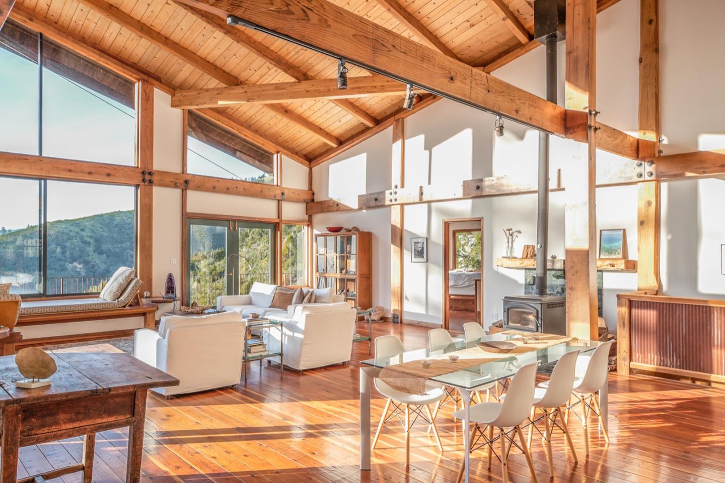 29141 Plasket Ridge Road Big Sur, CA 93920 - Photo 3 of 48 a living room with a table and chairs