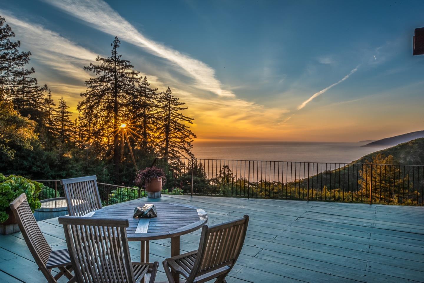 29141 Plasket Ridge Road Big Sur, CA 93920 - Photo 10 of 48 a table and chairs with wooden floor in front of house