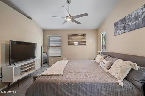 a bedroom with a bed and a flat screen tv