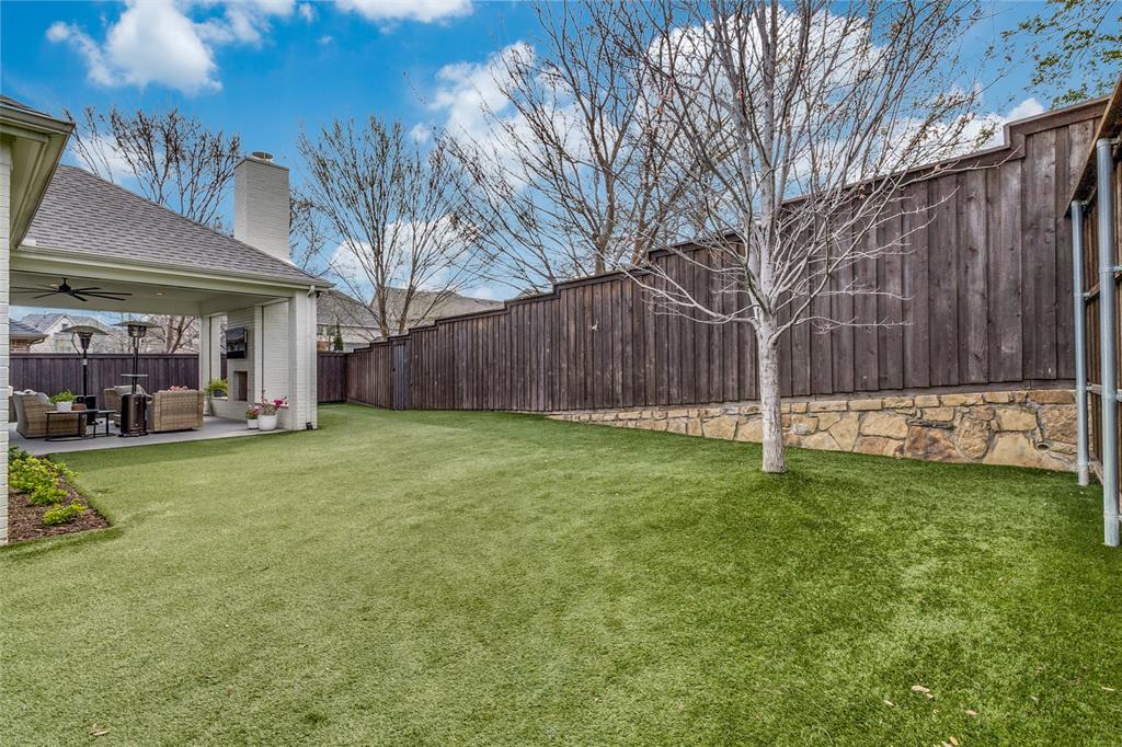7533 Garonne Street Dallas, TX 75231 - Photo 28 of 32 a view of a backyard with a garden