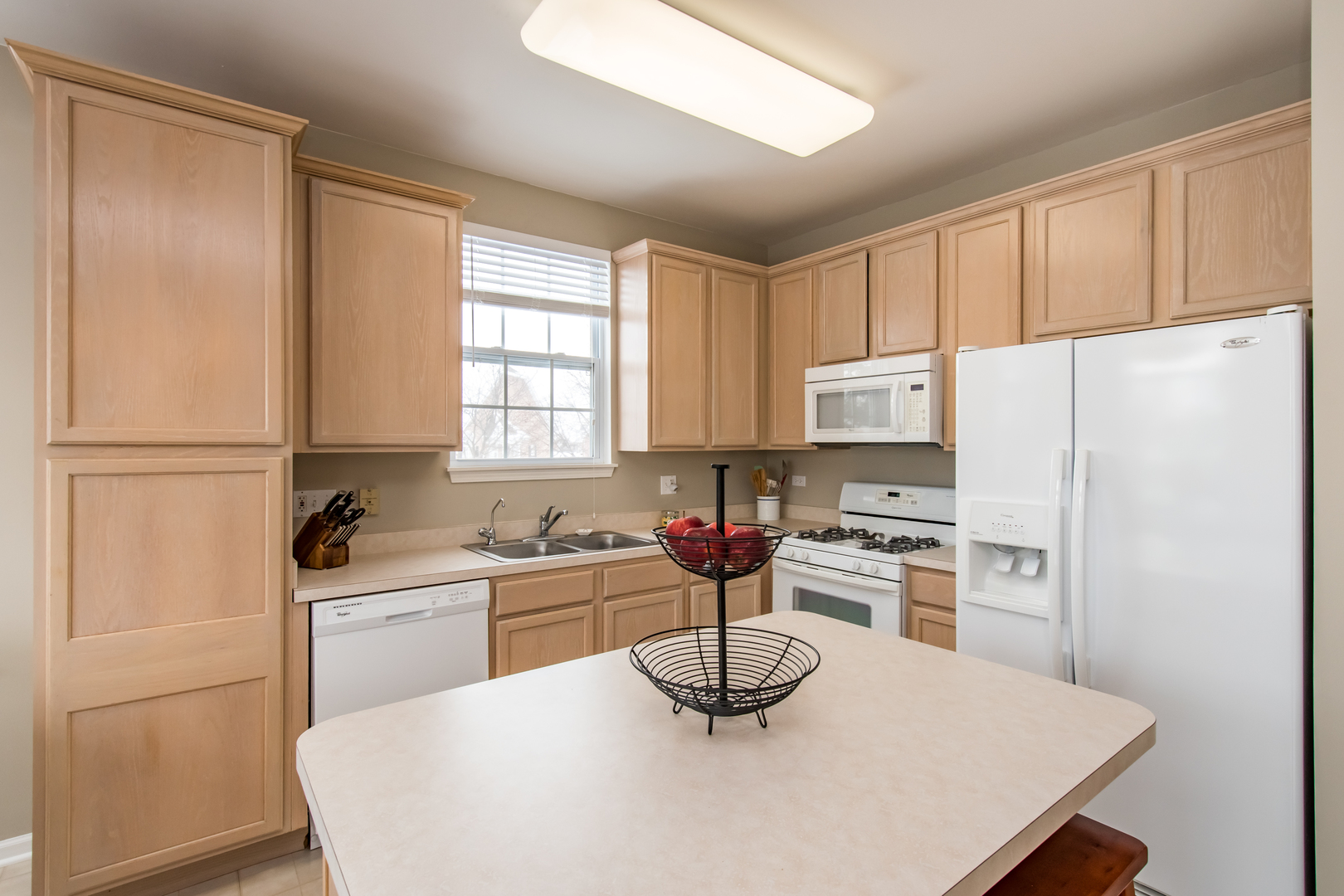717 Pheasant Trail St. Charles, IL 60174 - Photo 12 of 32 a kitchen with stainless steel appliances a refrigerator a sink a stove a table and chairs