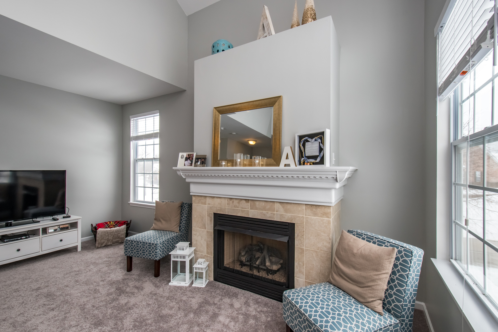 717 Pheasant Trail St. Charles, IL 60174 - Photo 6 of 32 a living room with furniture a flat screen tv and a fireplace