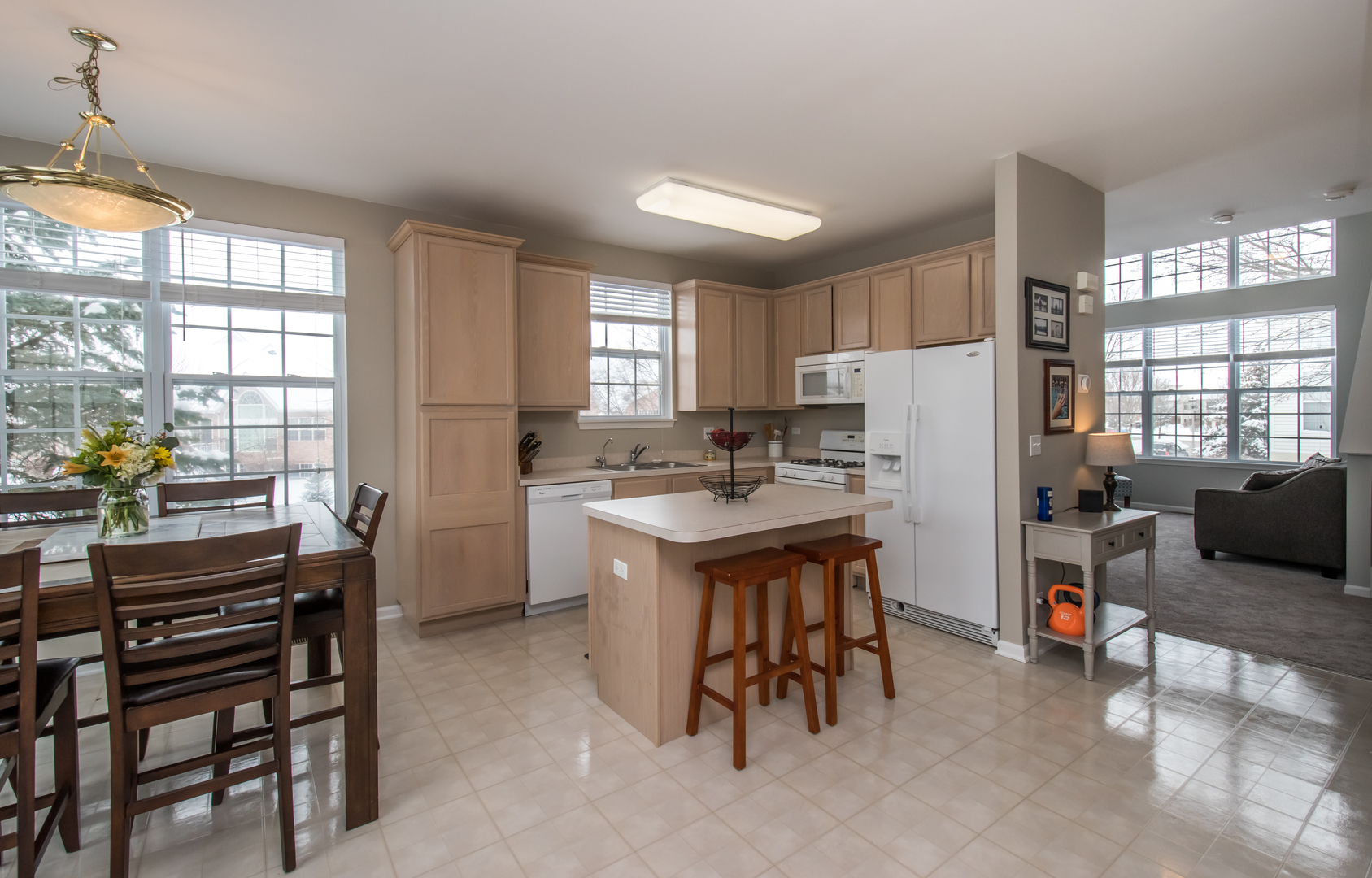 717 Pheasant Trail St. Charles, IL 60174 - Photo 7 of 32 a kitchen with refrigerator a table and chairs in it