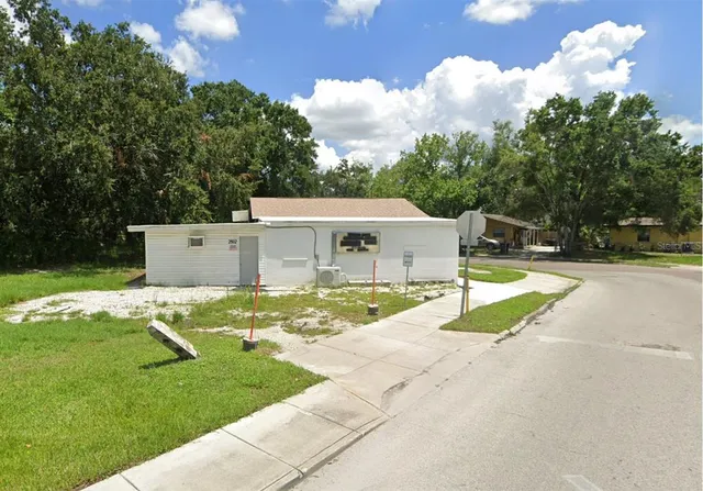 a view of a house with backyard and a patio