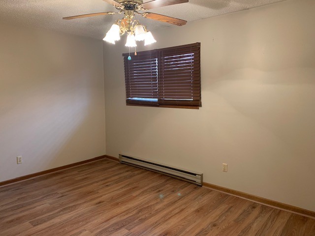 507 Jenkran Street, Unit 4 Morrison, IL 61270 - Photo 6 of 11 wooden floor in an empty room with a window
