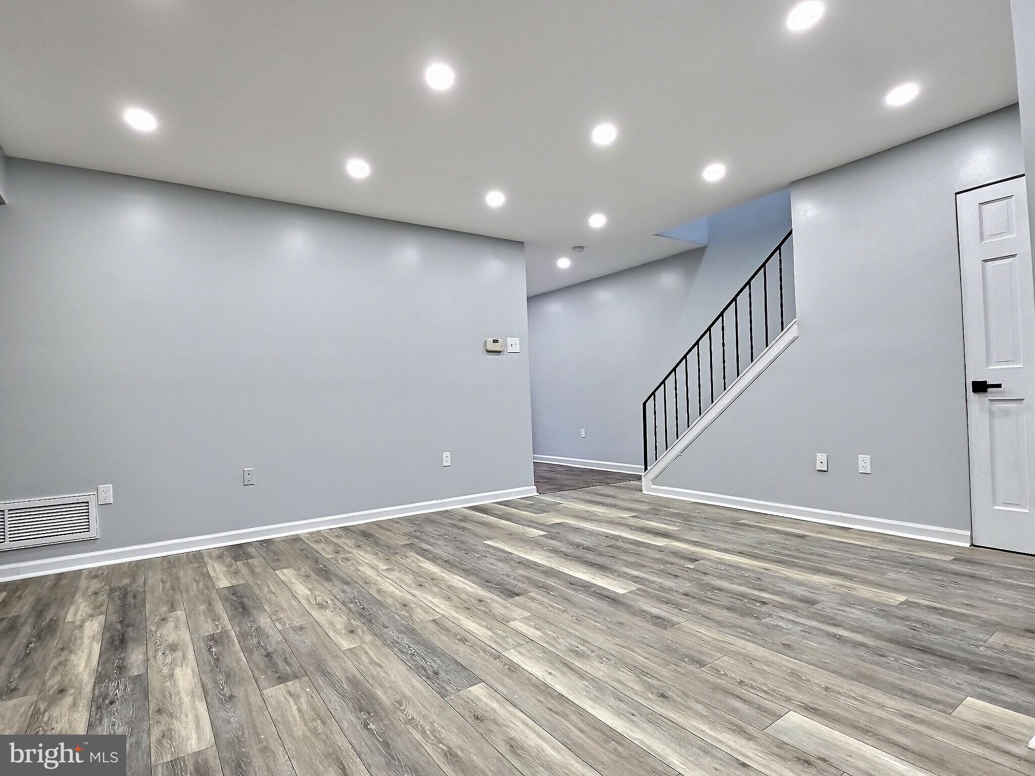 1213 Deer Run Reading, PA 19606 - Photo 12 of 42 an empty room with wooden floor and windows