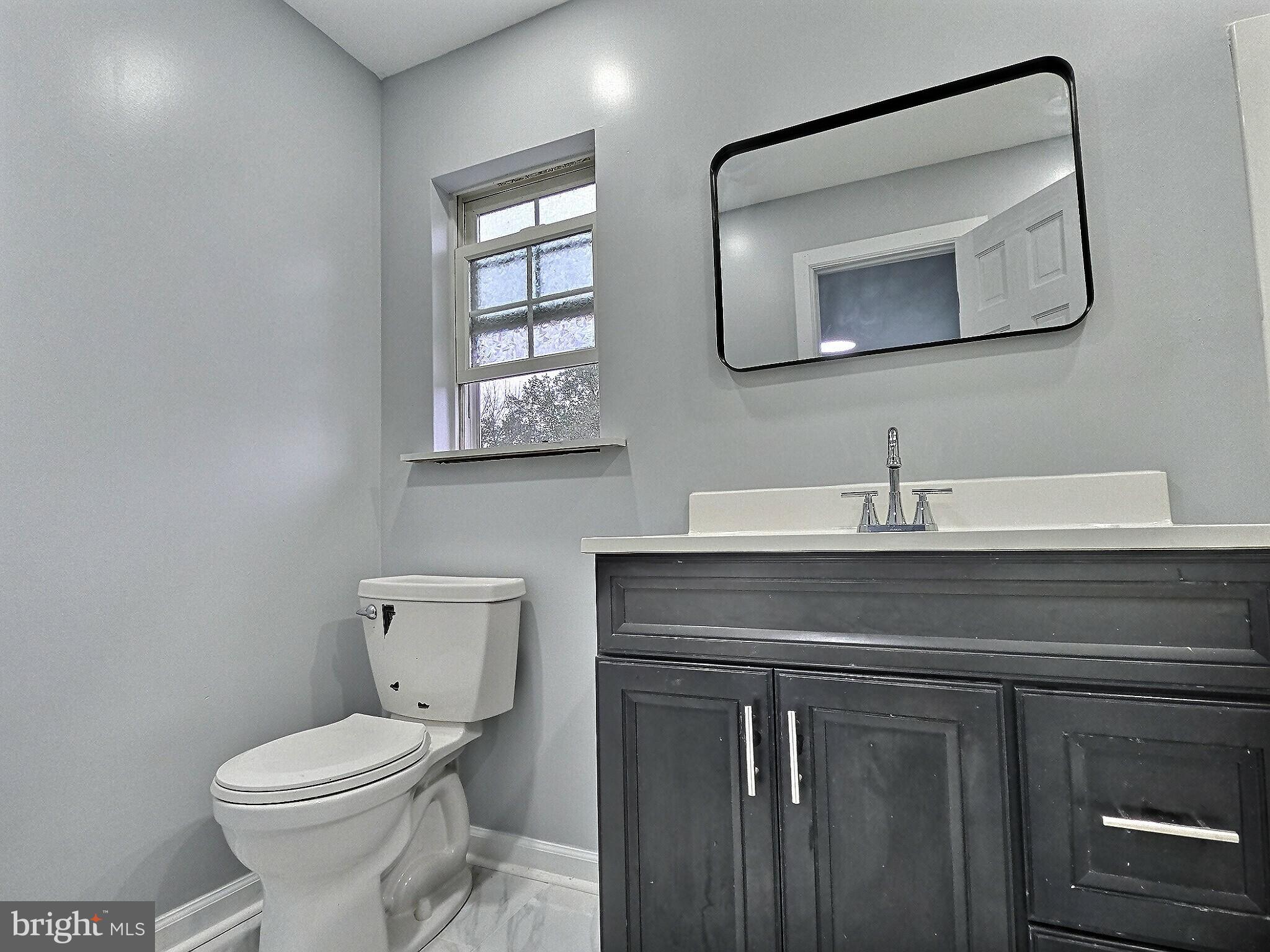1213 Deer Run Reading, PA 19606 - Photo 20 of 42 a bathroom with a toilet sink and mirror