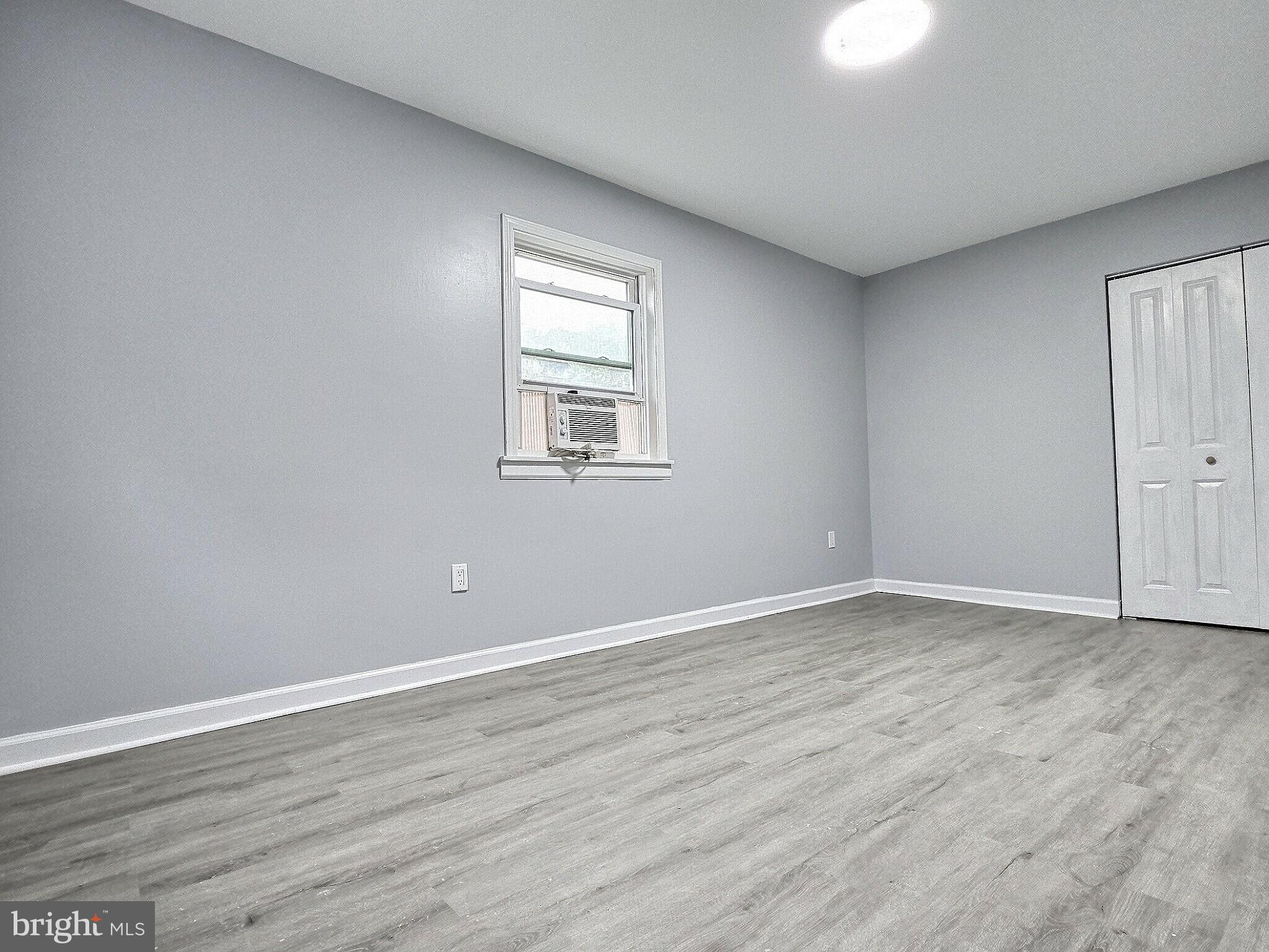 1213 Deer Run Reading, PA 19606 - Photo 27 of 42 a view of an empty room with wooden floor and a window