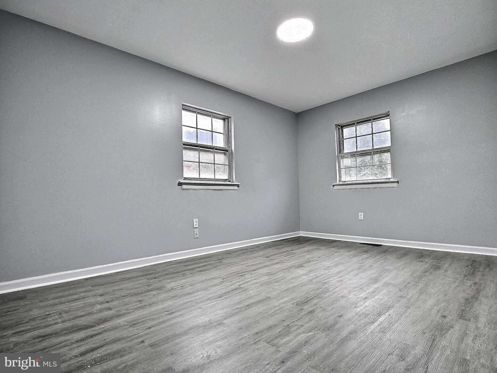 1213 Deer Run Reading, PA 19606 - Photo 29 of 42 an empty room with wooden floor and windows