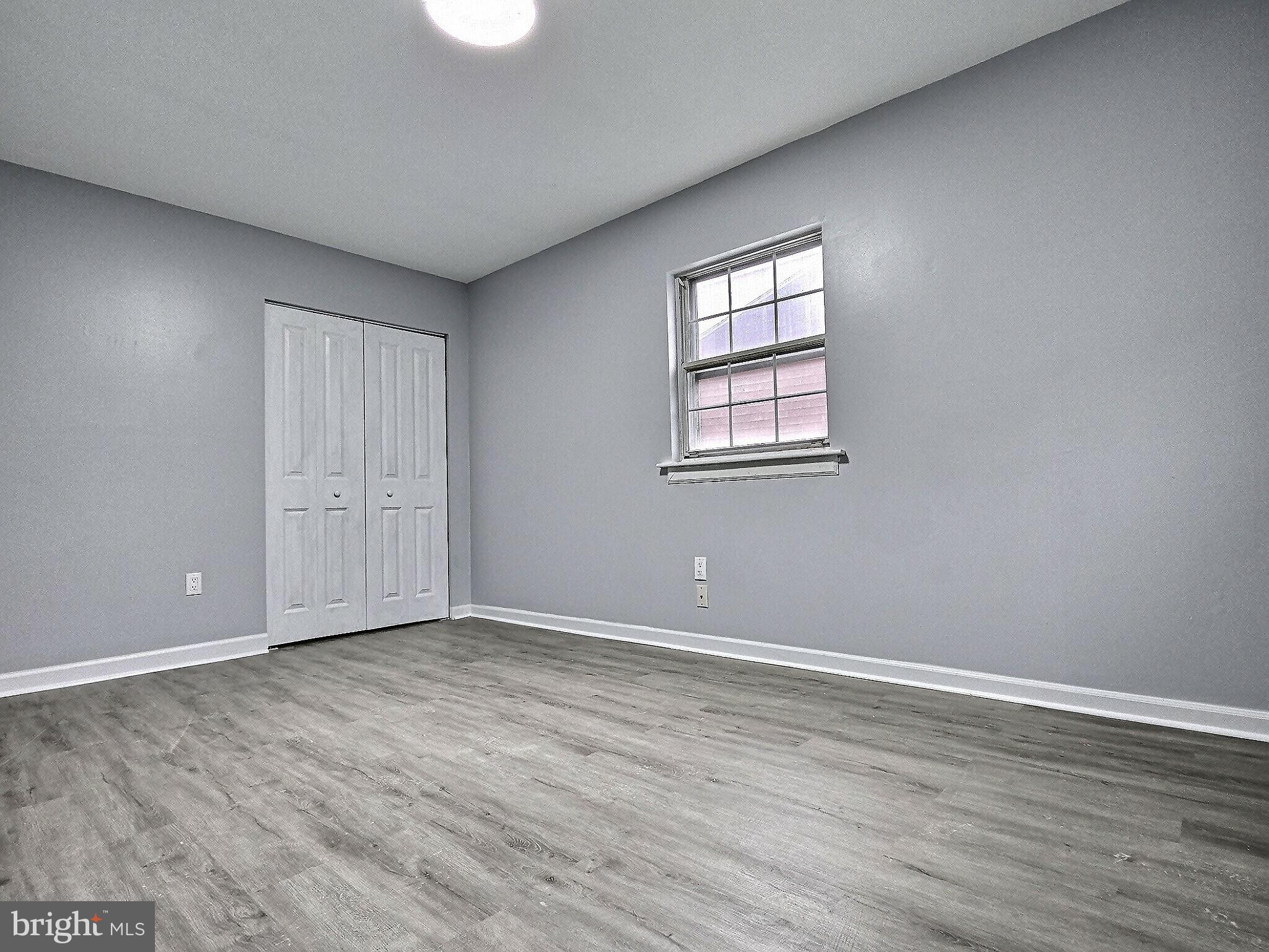 1213 Deer Run Reading, PA 19606 - Photo 31 of 42 a view of an empty room with wooden floor and a window