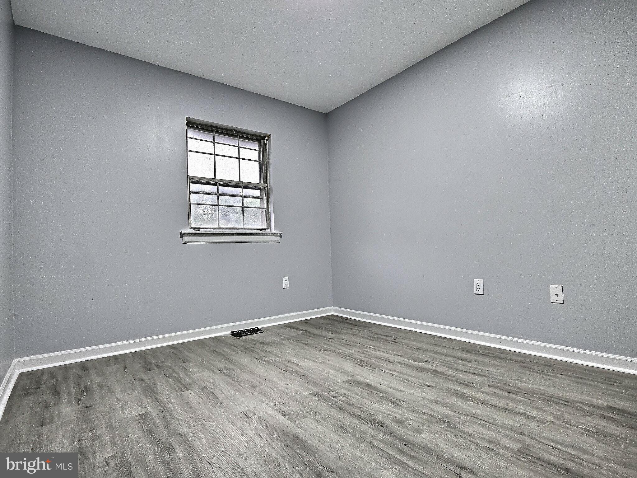 1213 Deer Run Reading, PA 19606 - Photo 33 of 42 a view of an empty room with wooden floor and a window