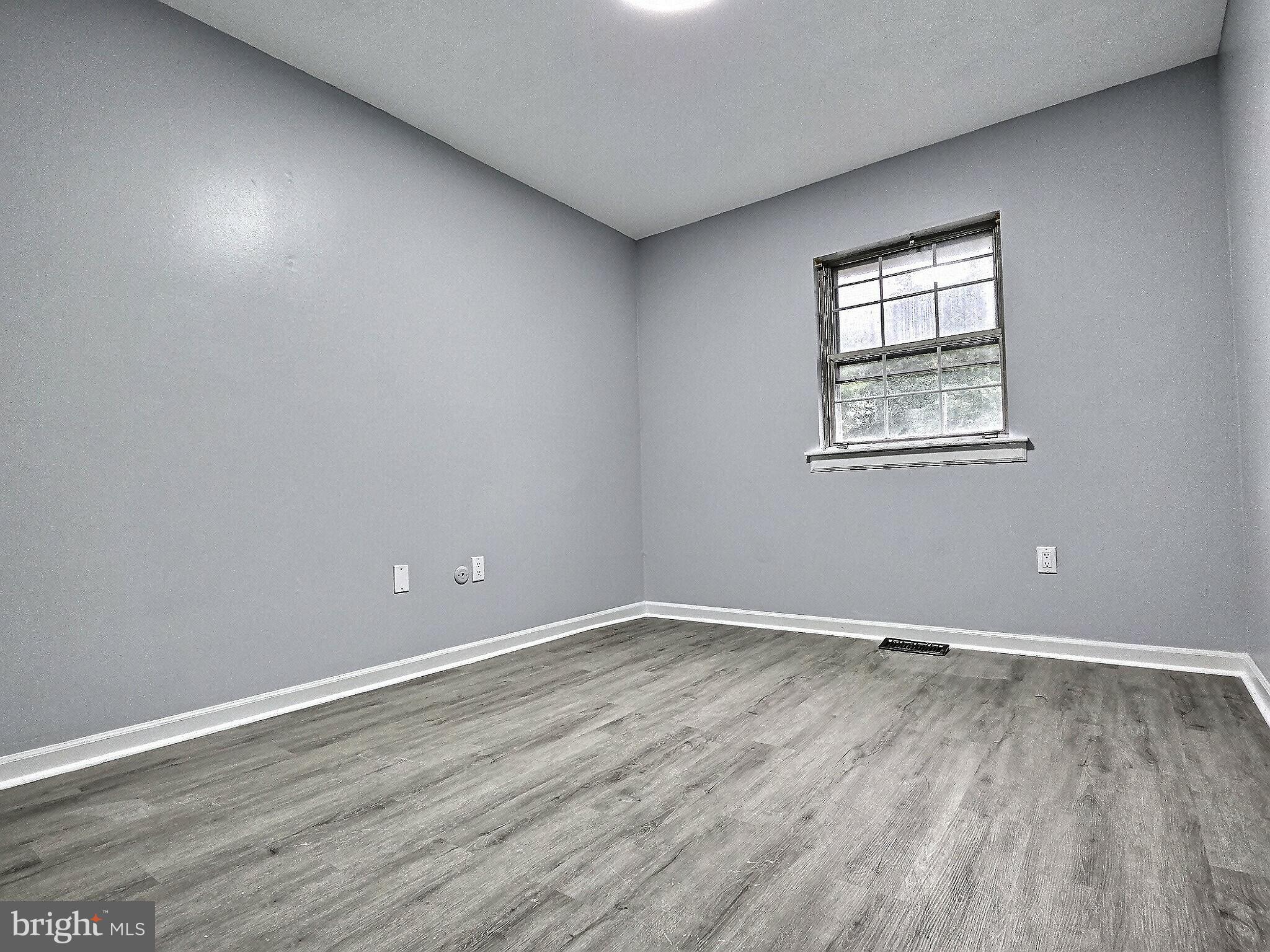 1213 Deer Run Reading, PA 19606 - Photo 35 of 42 a view of an empty room with wooden floor and a window