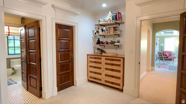 426 West Center Street Parowan, UT 84761 - Photo 55 of 107 Hallway featuring architectural trim, multiple paneled doors, and built-in shelving with a base cabinet