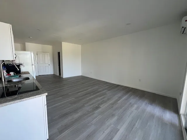 a kitchen with granite countertop a sink and a stove top oven
