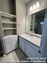 a bathroom with a sink a vanity and a mirror