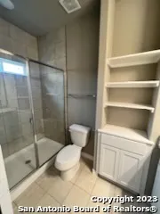 a bathroom with a toilet and a shower