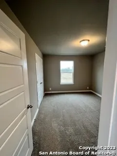 a view of an empty room and a window