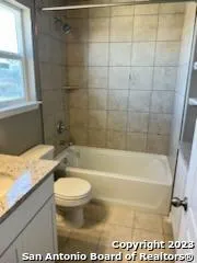 a bathroom with a sink a toilet and a bathtub
