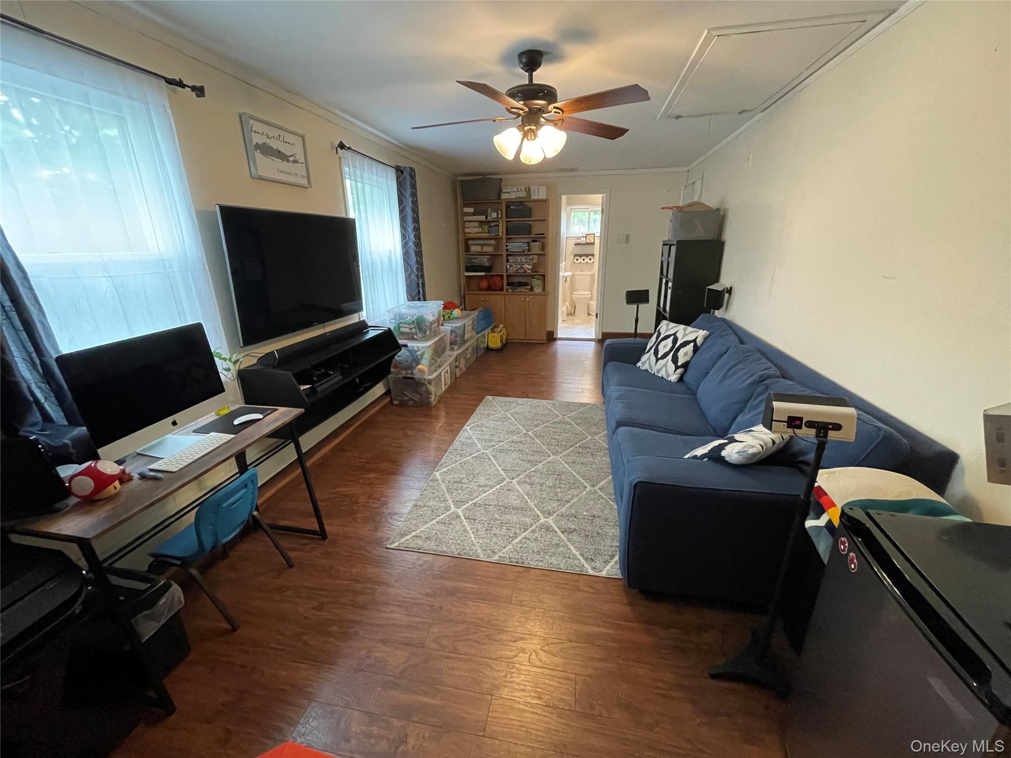 161 Hawkins Road Centereach, NY 11720 - Photo 14 of 16 a living room with furniture and a flat screen tv