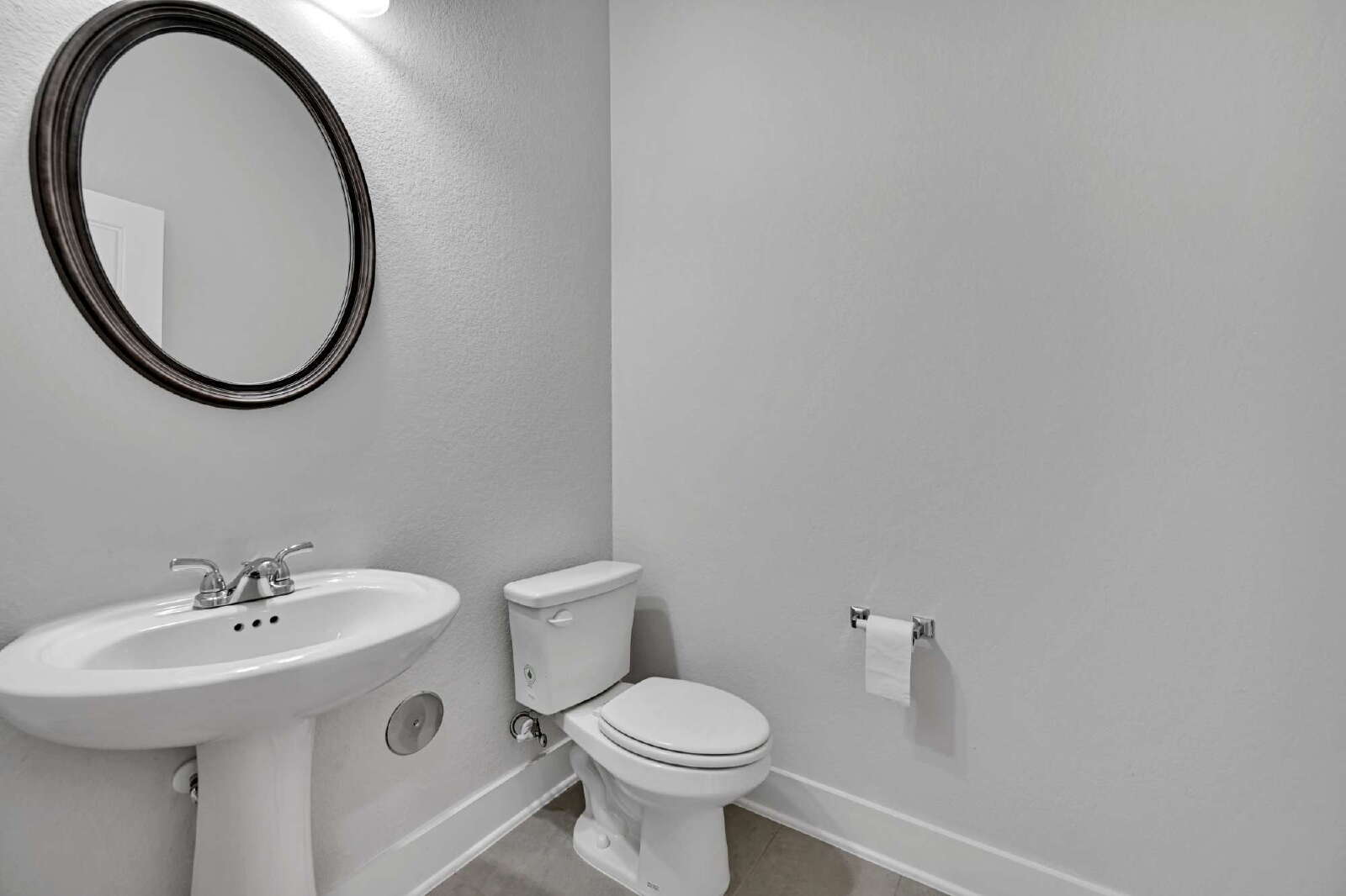 4420 Kings Cross Road Pflugerville, TX 78660 - Photo 21 of 25 A classic pedestal sink paired with neutral walls completes this functional half bath.