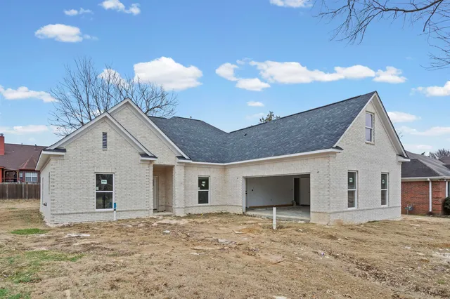 a view of a house with a yard and garage