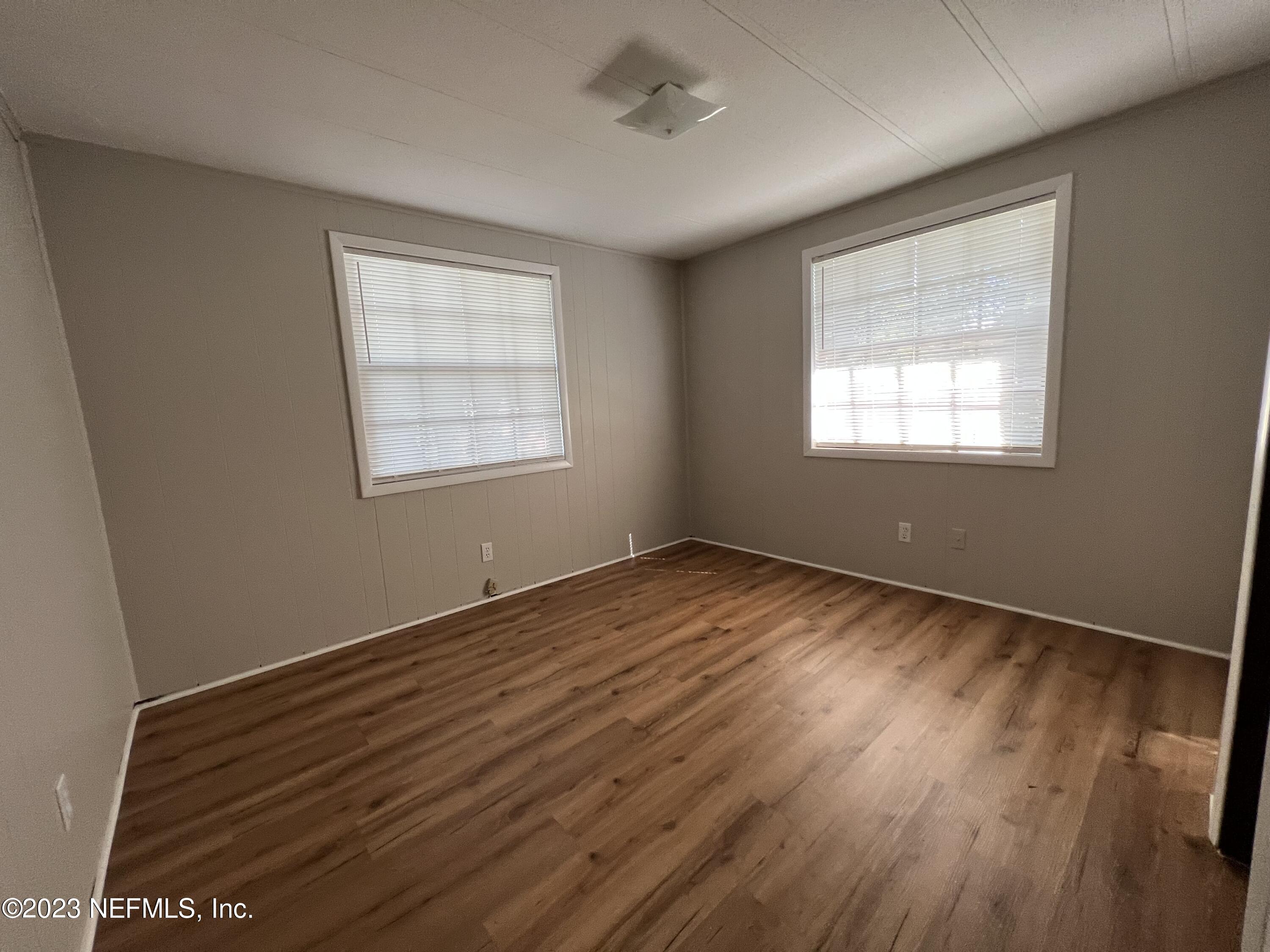 765 Ebb Tide Drive Fleming Island, FL 32003 - Photo 12 of 15 a view of an empty room with wooden floor and a window