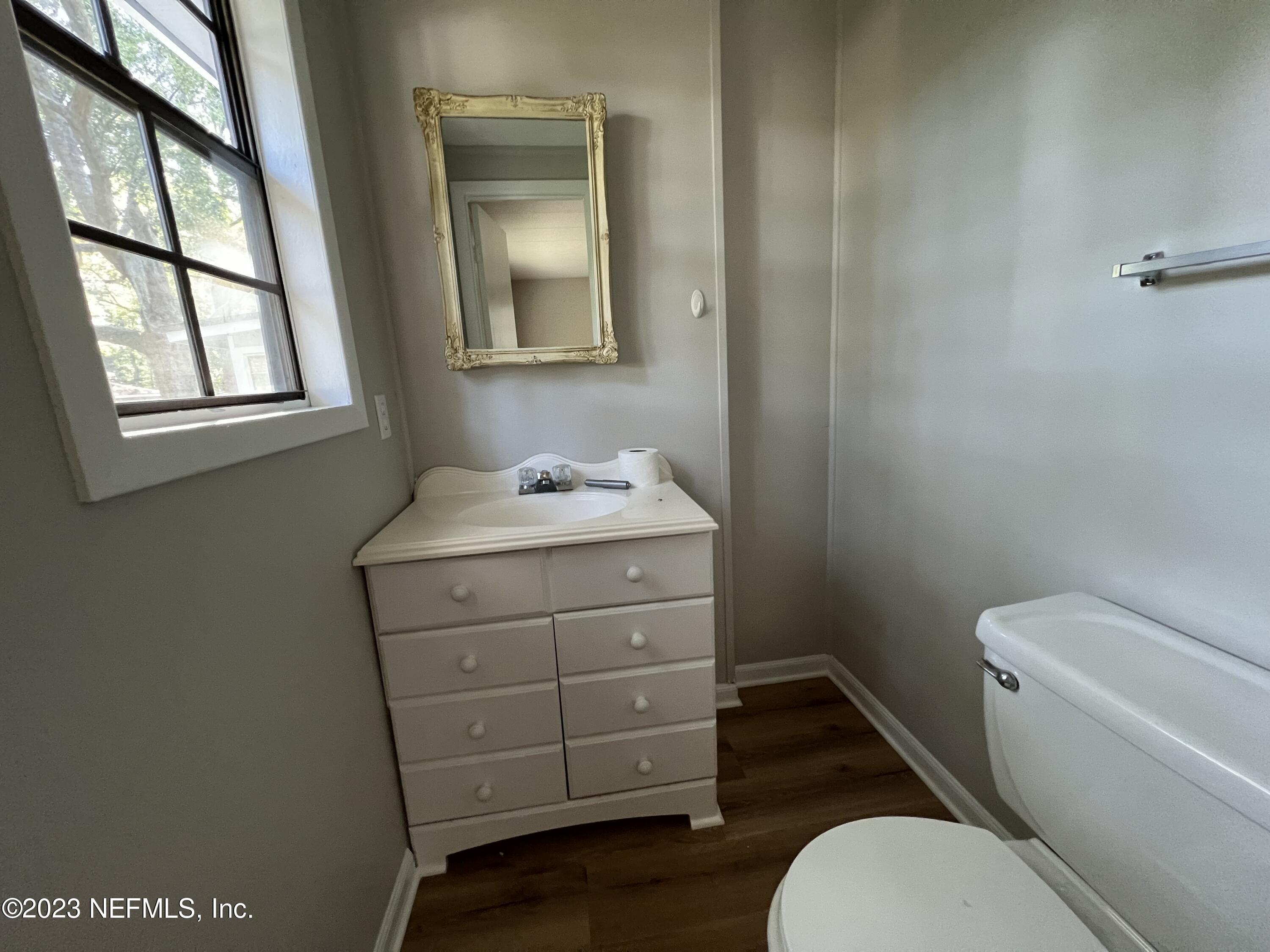 765 Ebb Tide Drive Fleming Island, FL 32003 - Photo 13 of 15 a bathroom with a toilet a sink a vanity and mirror