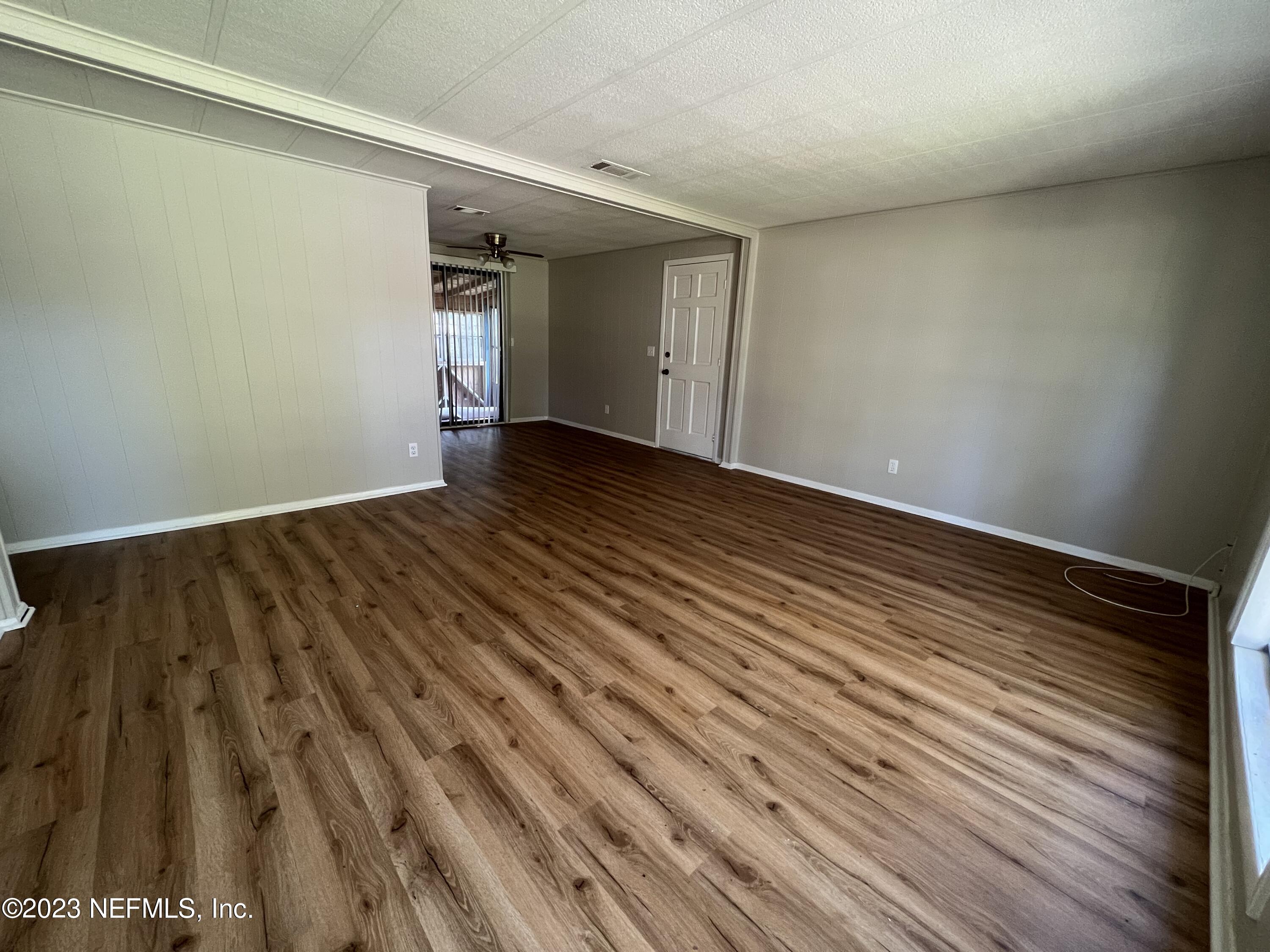 765 Ebb Tide Drive Fleming Island, FL 32003 - Photo 3 of 15 a view of an empty room with wooden floor and a window