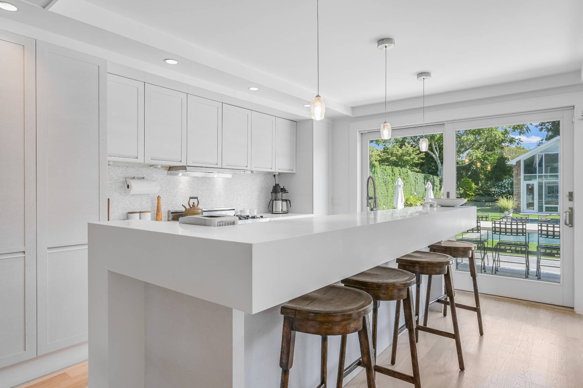 Undisclosed Address Bridgehampton, NY 11932 - Photo 18 of 35 a kitchen with a table chairs sink and cabinets