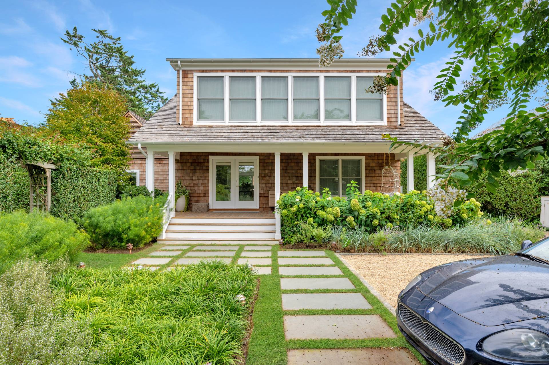 Undisclosed Address Bridgehampton, NY 11932 - Photo 2 of 35 a front view of a house with a yard