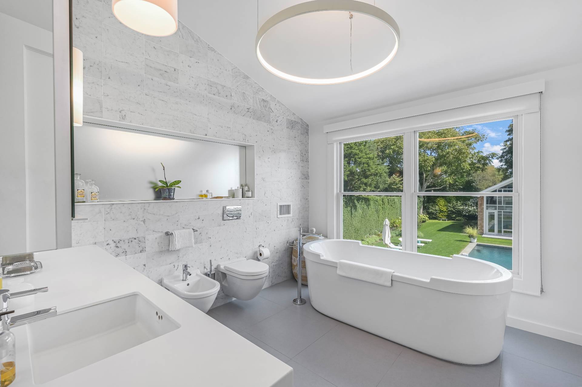Undisclosed Address Bridgehampton, NY 11932 - Photo 26 of 35 a bathroom with a sink a bathtub and a window