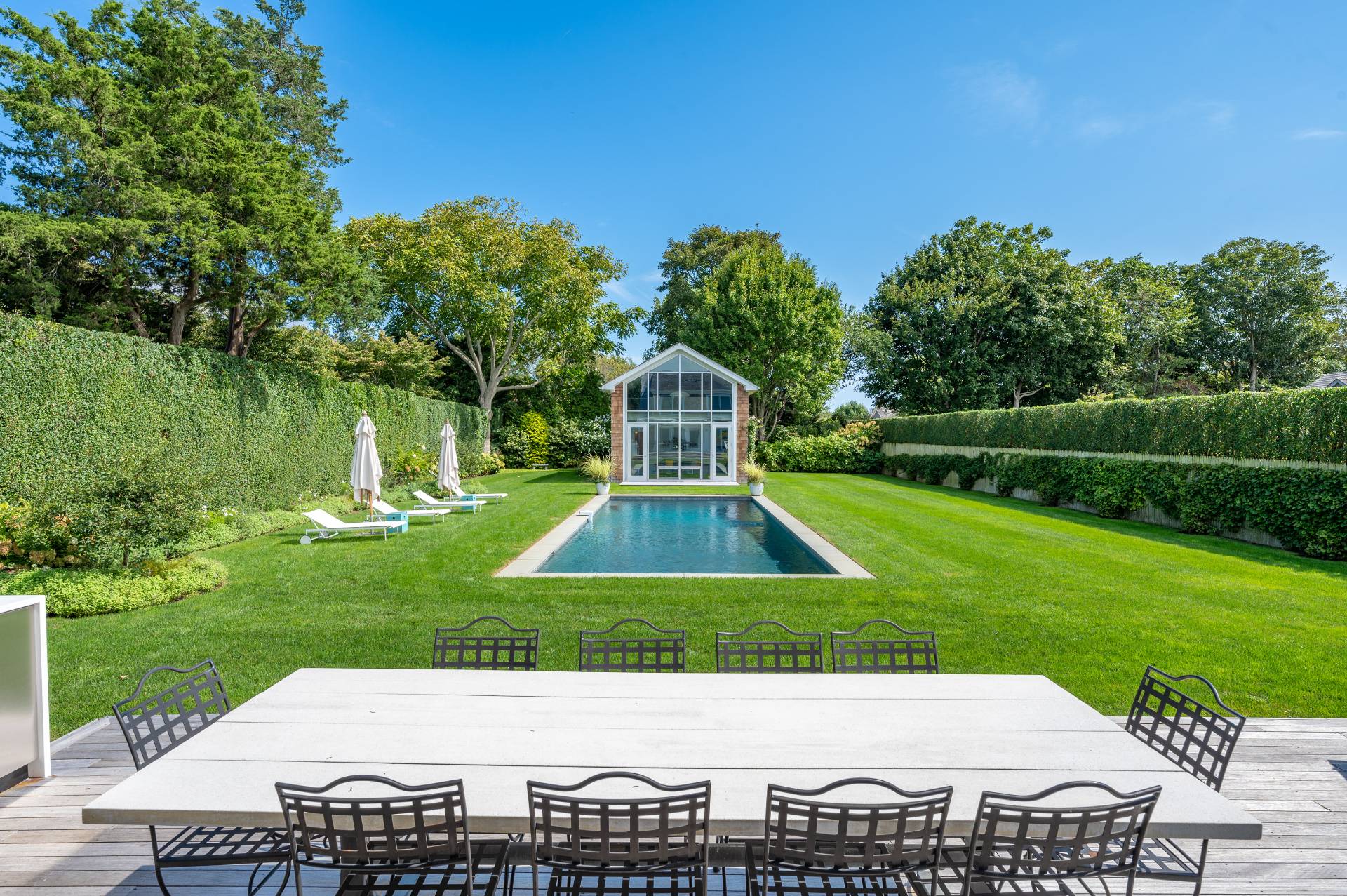 Undisclosed Address Bridgehampton, NY 11932 - Photo 7 of 35 a view of a backyard with a garden and plants