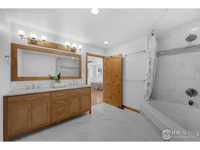 a bathroom with a granite countertop sink mirror and shower