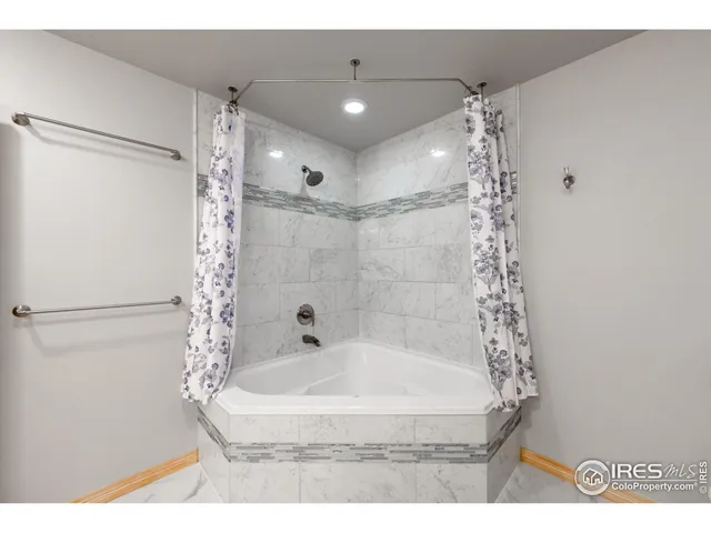 a bathroom with a shower and a tub
