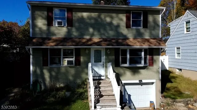 a front view of a house with yard and balcony