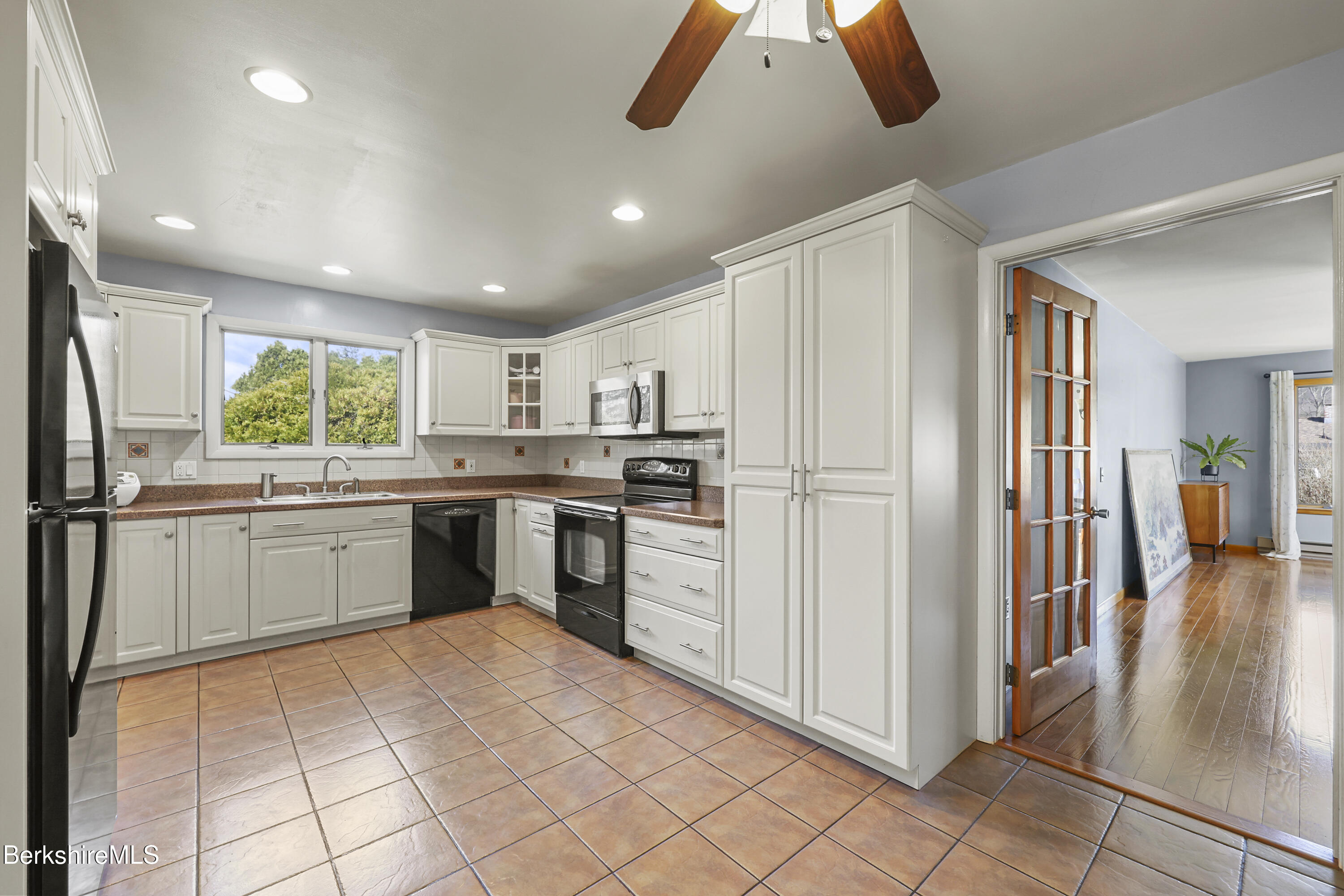 43 Baldwin Avenue Pittsfield, MA 01201 - Photo 12 of 31 a kitchen with a sink stainless steel appliances and white cabinets