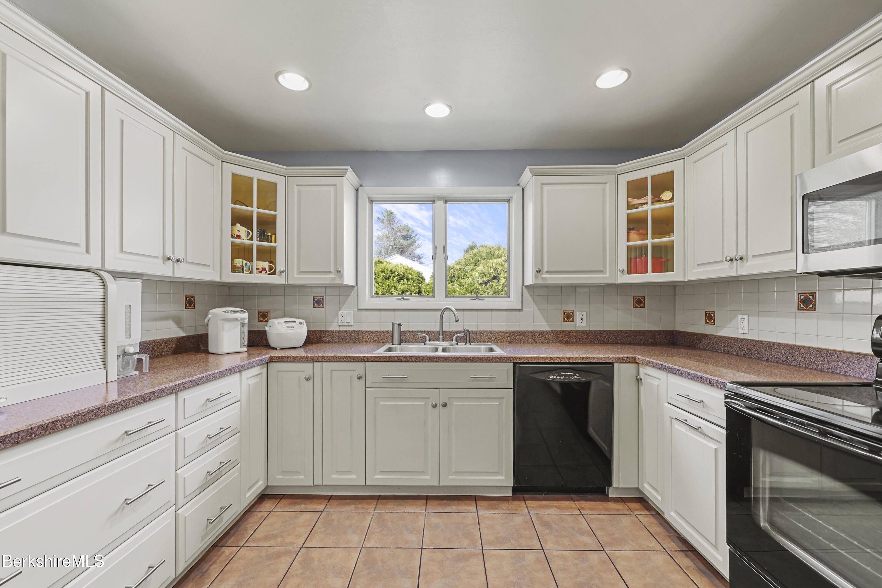 43 Baldwin Avenue Pittsfield, MA 01201 - Photo 13 of 31 a kitchen with a sink stove top oven and cabinets