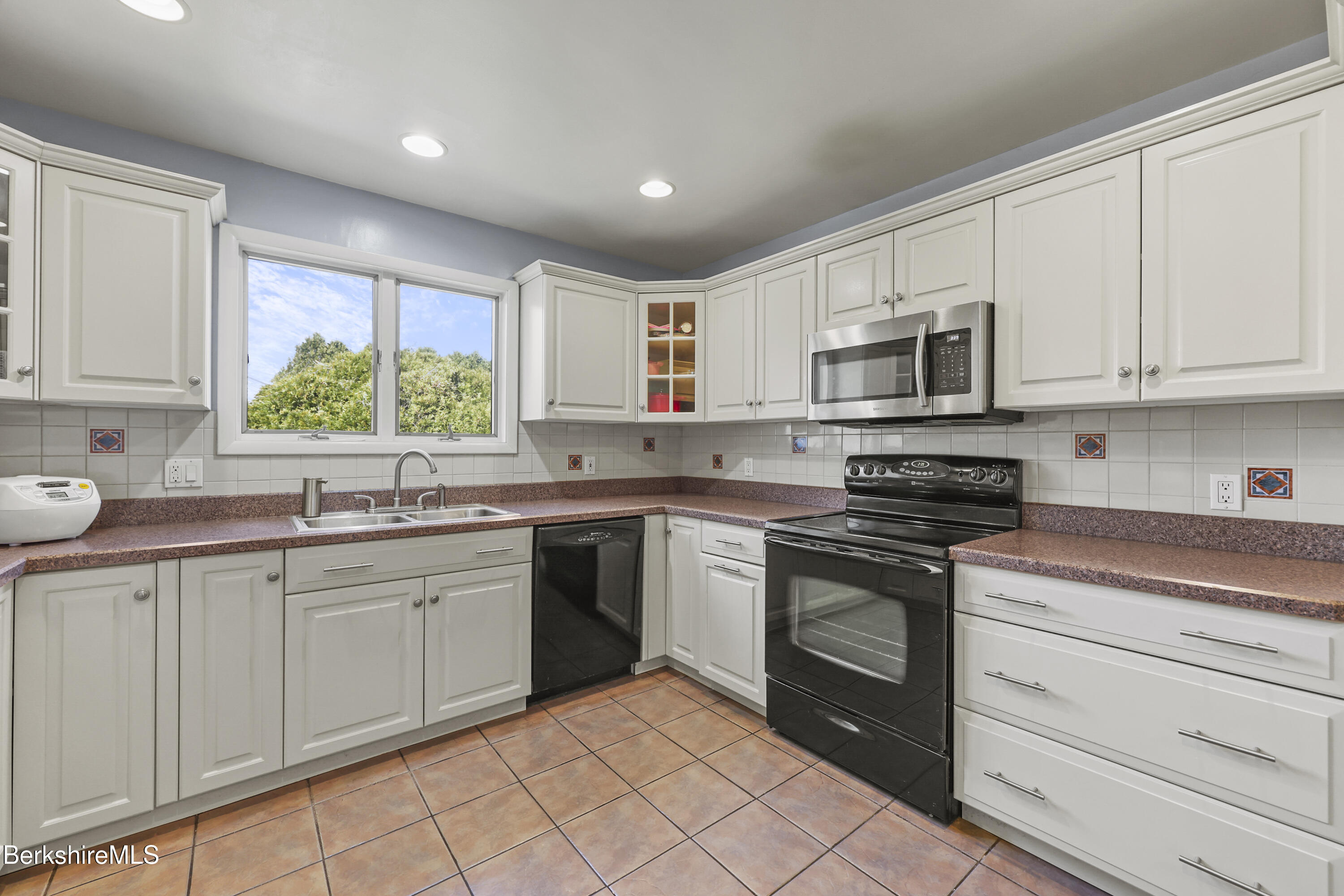 43 Baldwin Avenue Pittsfield, MA 01201 - Photo 15 of 31 a kitchen with kitchen island granite countertop white cabinets white stainless steel appliances with a sink and dishwasher