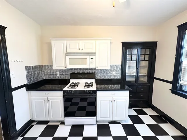 a kitchen with a stove a sink and a refrigerator