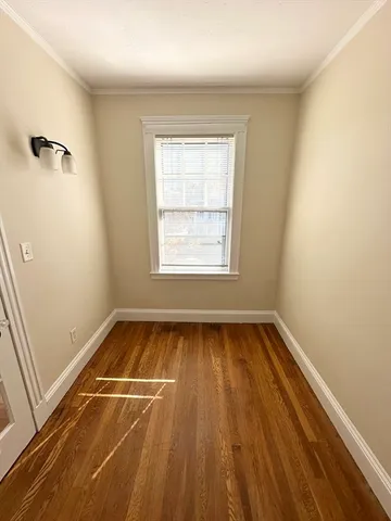 a view of a room with wooden floor and window