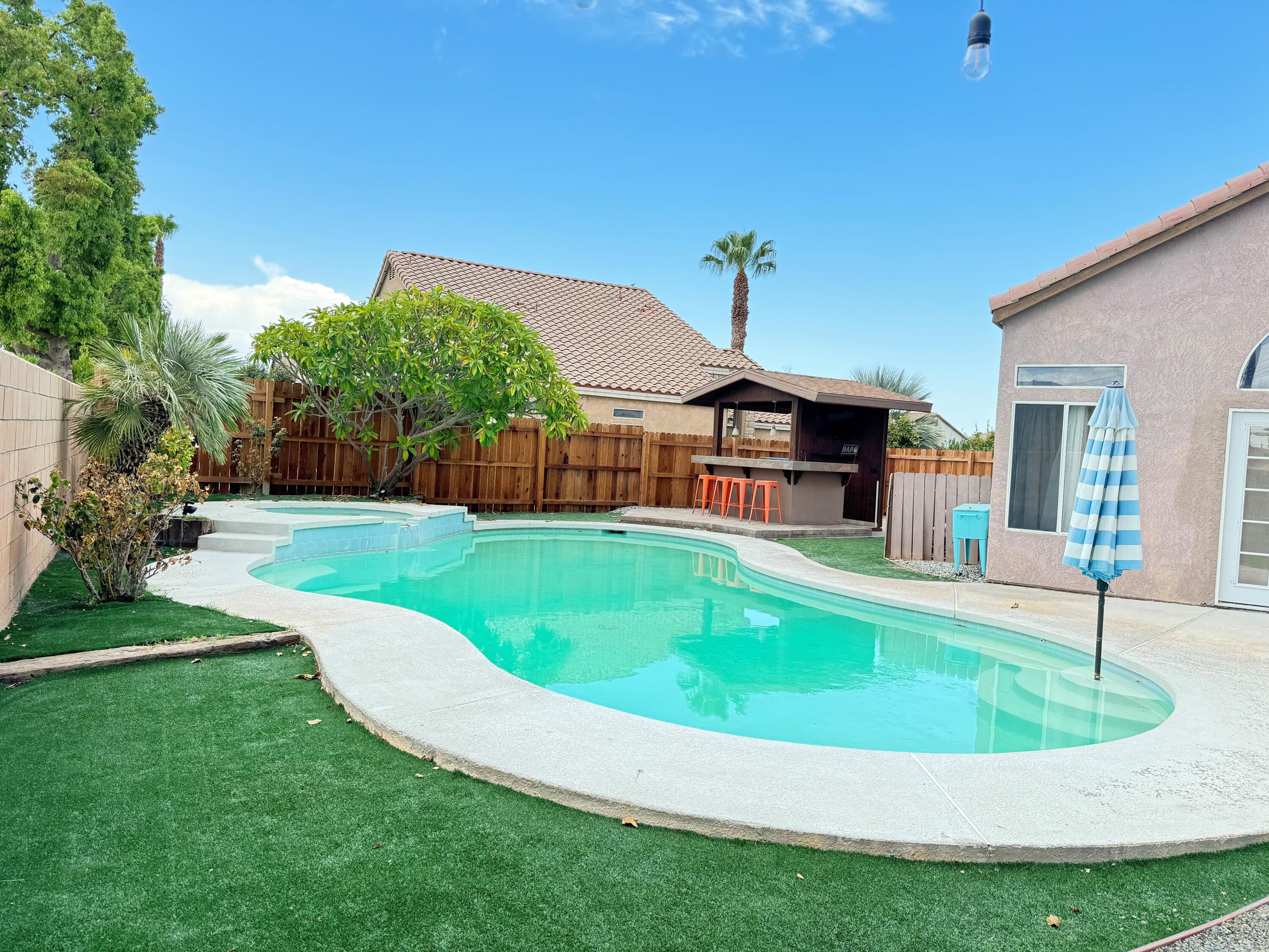 81032 Red Bluff Road Indio, CA 92201 - Photo 6 of 33 a view of a house with a swimming pool and sitting area